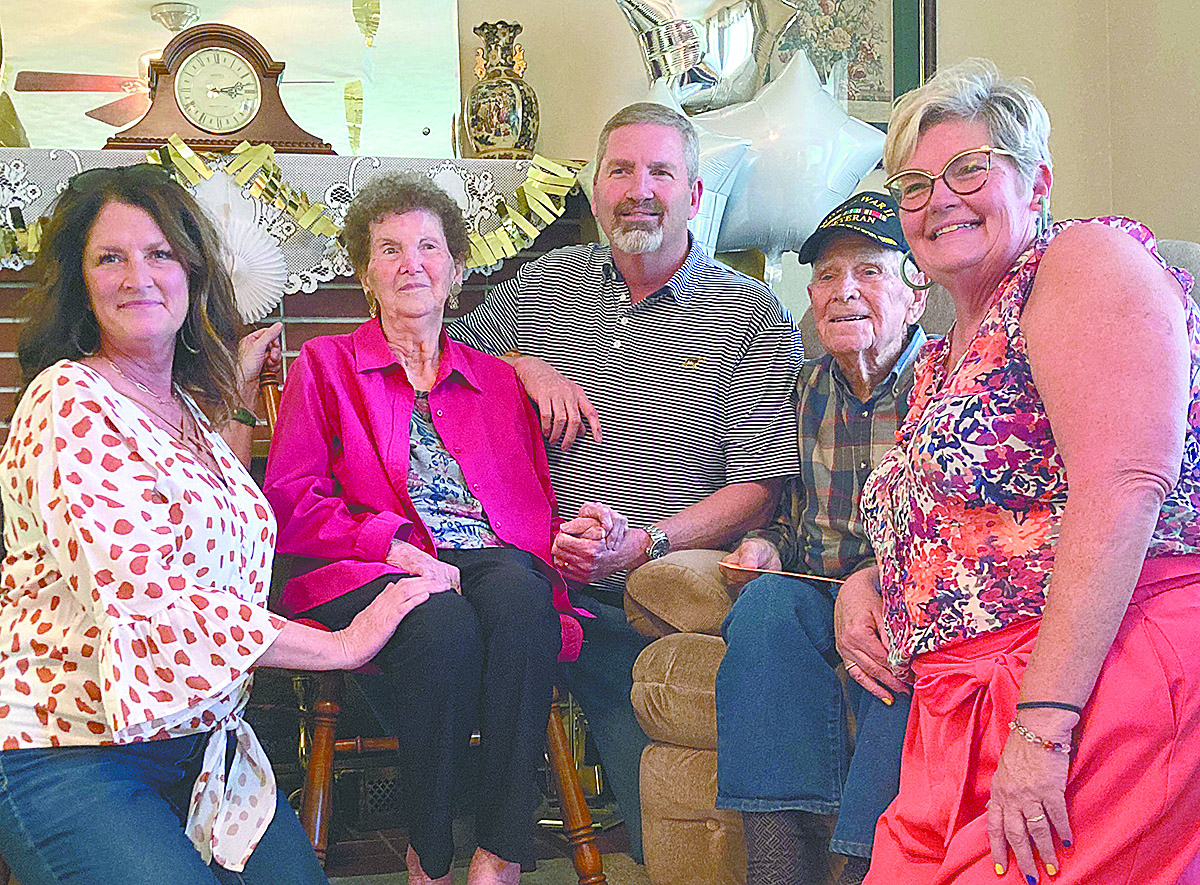 Robert Chappell at his 100th birthday celebration taking a photo with family members. 
